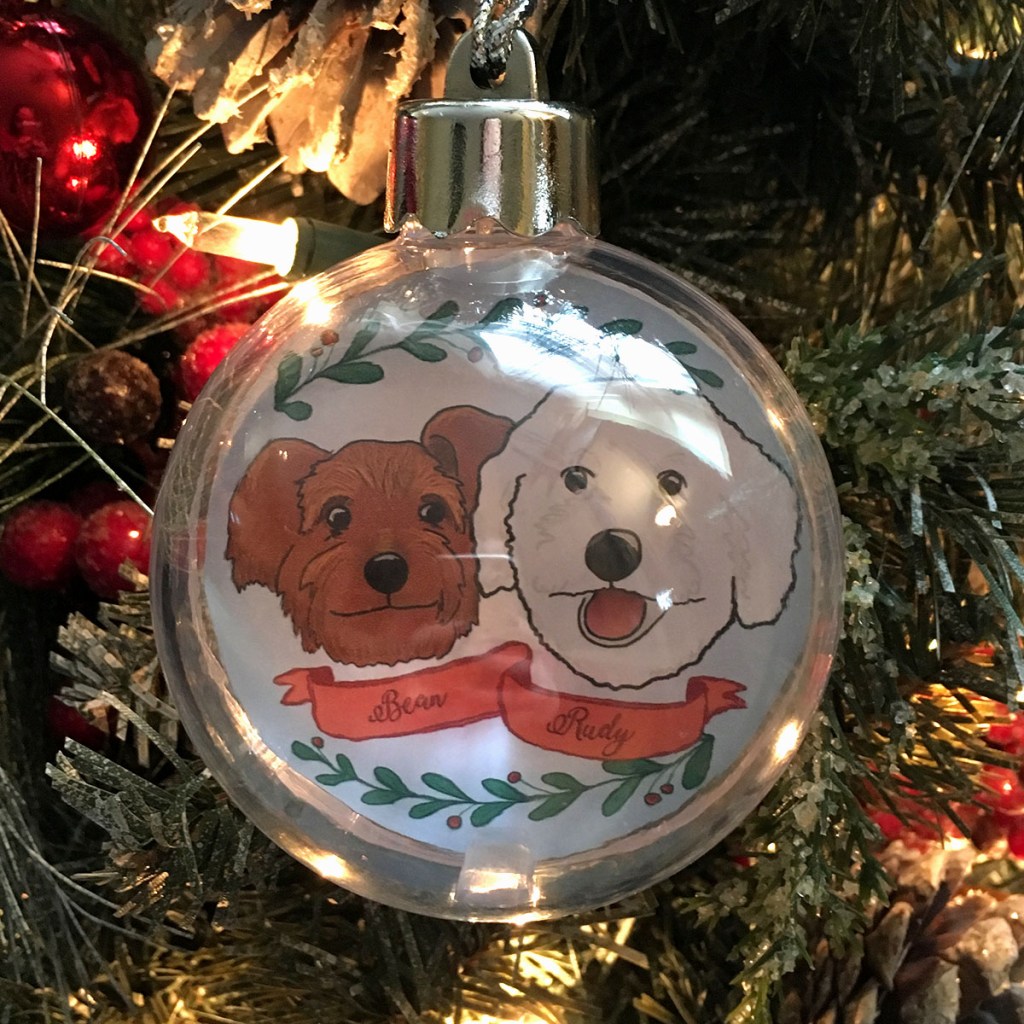 Holiday ornament with an illustrated portrait of two dogs named Bean and Rudy