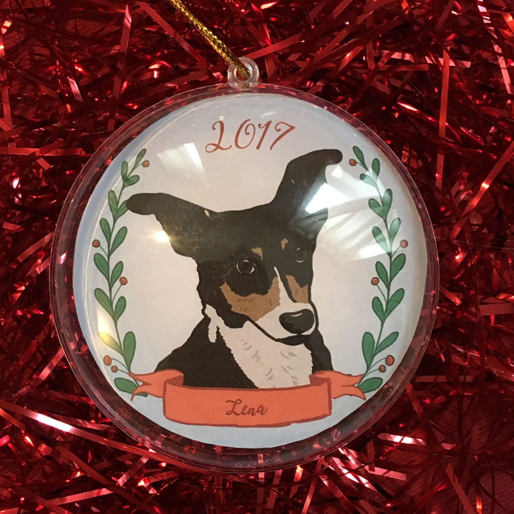 Holiday ornament with an illustrated portrait of a dog named Lena