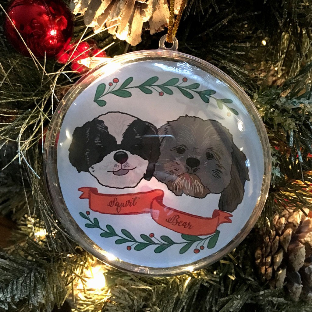 Holiday ornament with an illustrated portrait of two dogs named Squirt and Bean