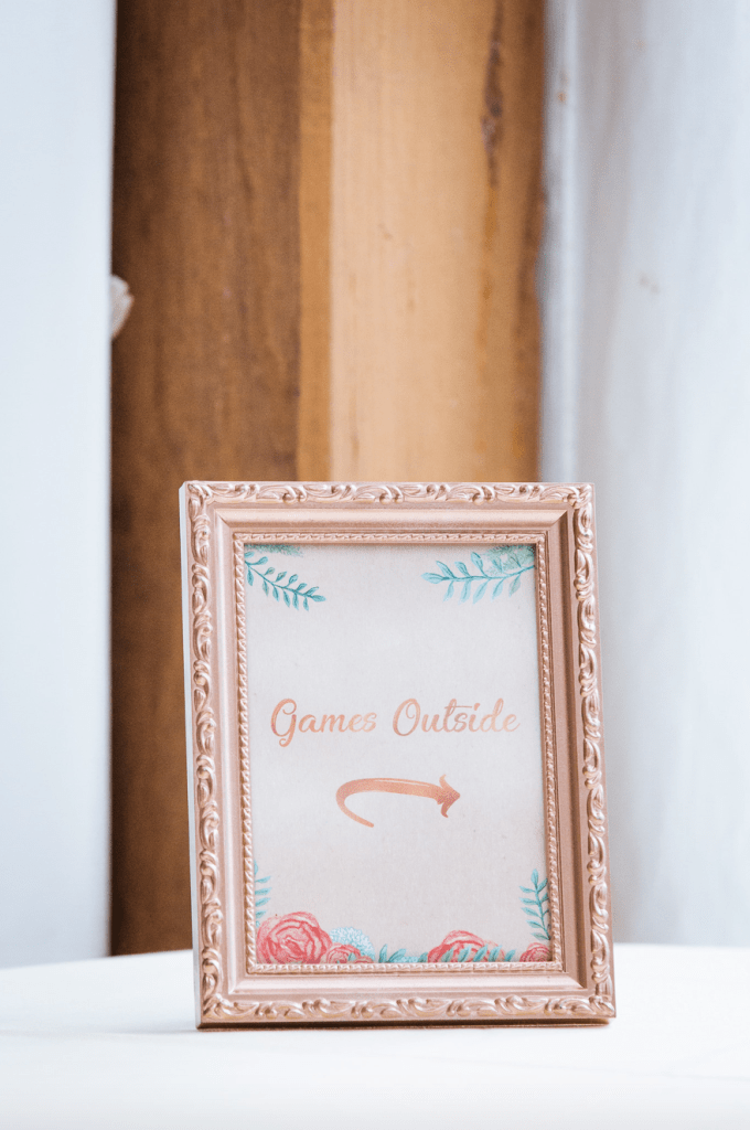 Framed sign that reads Games Outside with a calligraphic arrow that points outside.