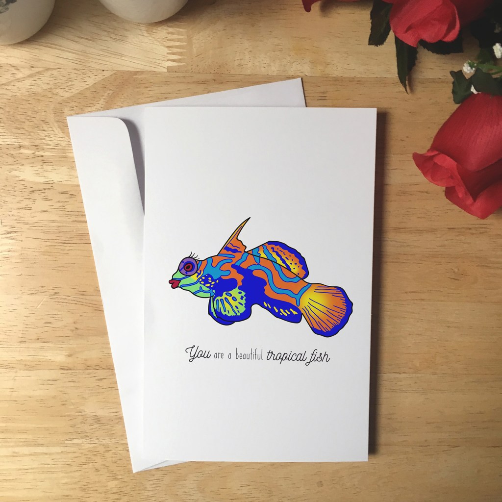 Greeting Card design with an illustration of a tropical fish that has red lipstick and eyelashes. The text reads You are a beautiful tropical fish.
