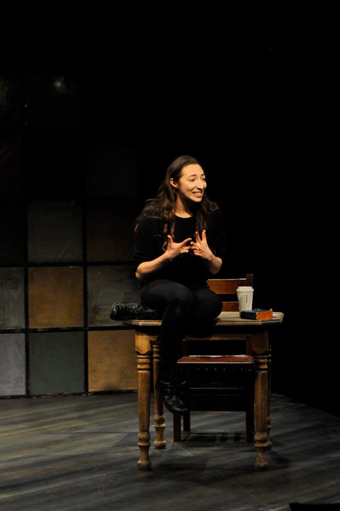 Arielle Beth Klein sitting on a table gesturing with her hands in "My Shiksa Boyfriend". Photo by Lauren Bryant.