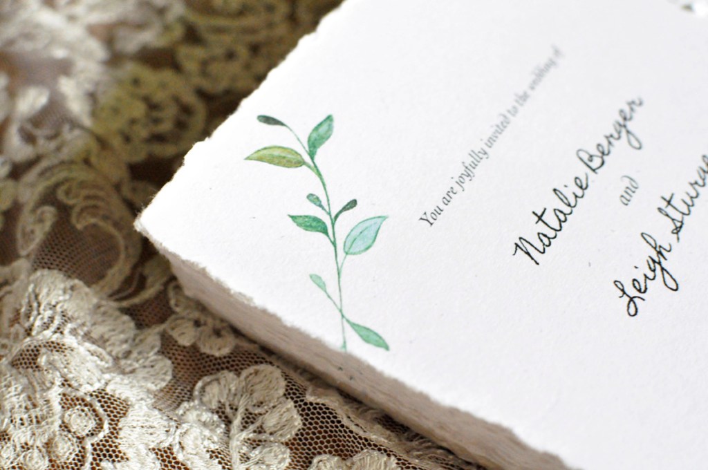 Stack of Wedding Invitations. Detail of watercolor leaves.