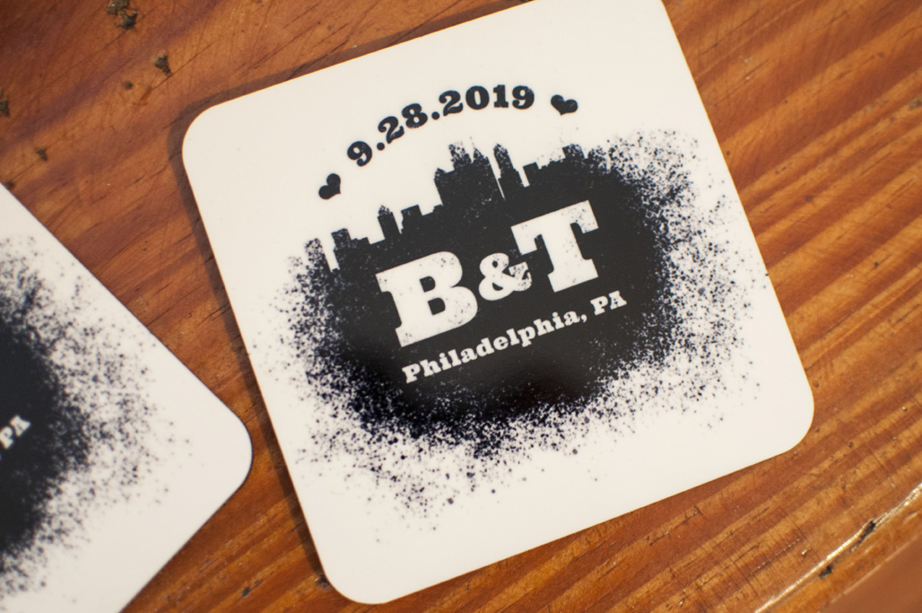A coaster with a spray paint design that features the Philadelphia skyline and reads 9.28.2019 B&T Philadelphia, PA